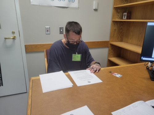 Clinic client reviewing his clemency paperwork.